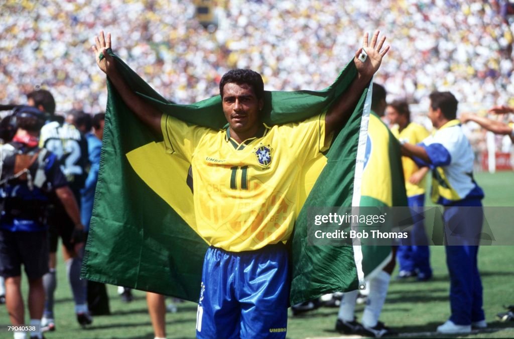 1994 World Cup Final. Pasadena, USA. 17th July, 1994. Brazil 0 v Italy 0. (Brazil won 3-2 on penalties). Brazilian star Romario drapes himself in his country's flag after Brazil won the World Cup by beating Italy on penalties.