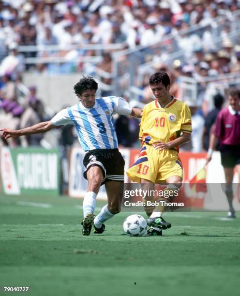 World Cup Finals, Los Angeles, USA, 3rd July Romania 3 v Argentina 2, Romania's Gheorghe Hagi is challenged for the ball by Argentina's Jose Chamot