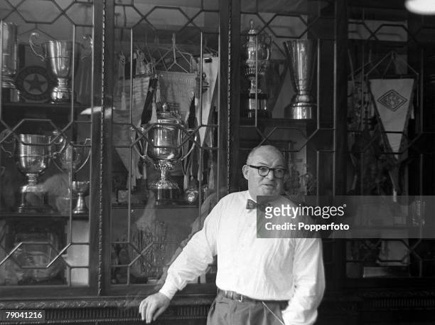 London, England Arsenal Football Club, Tommy Whitaker stands in front of the trophy cabinet at Highbury