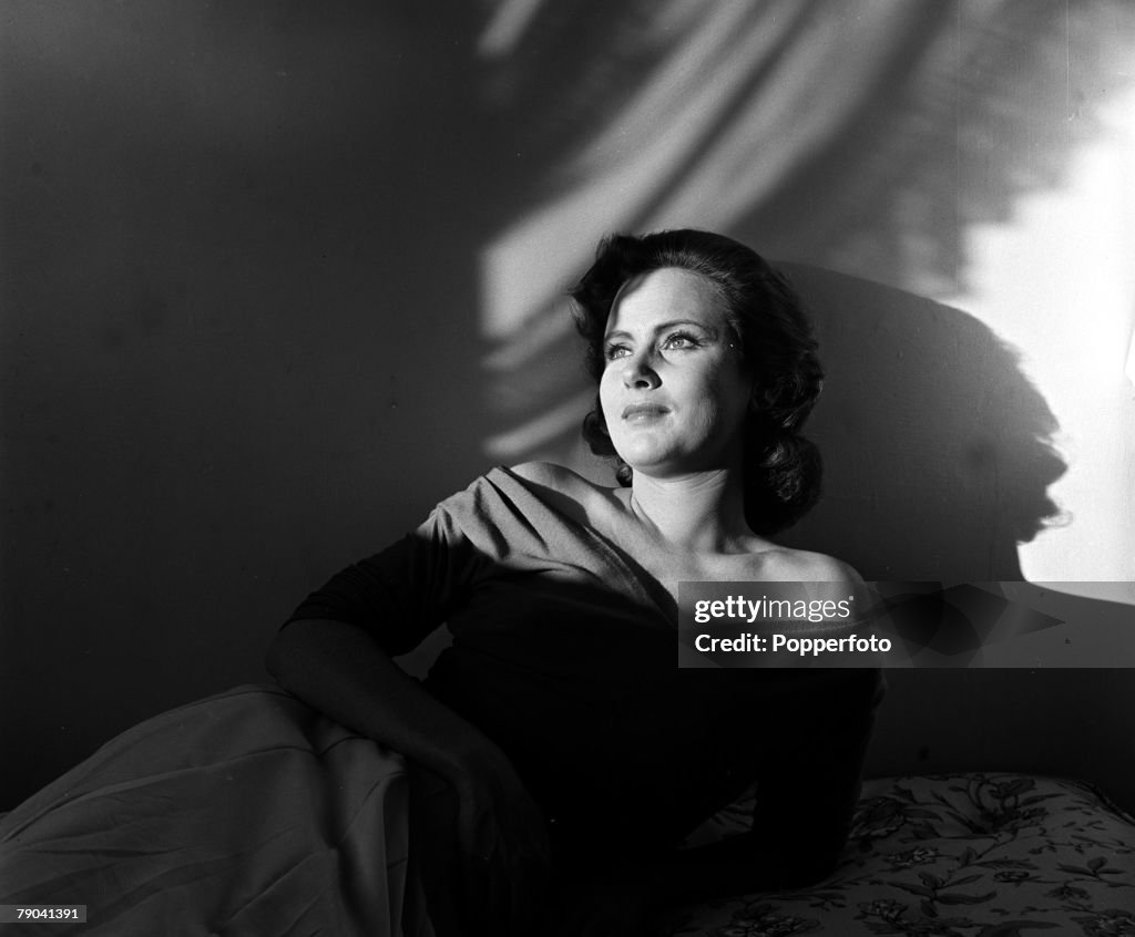 England. 1950. A portrait of actress Nadia Gray reclining at home.