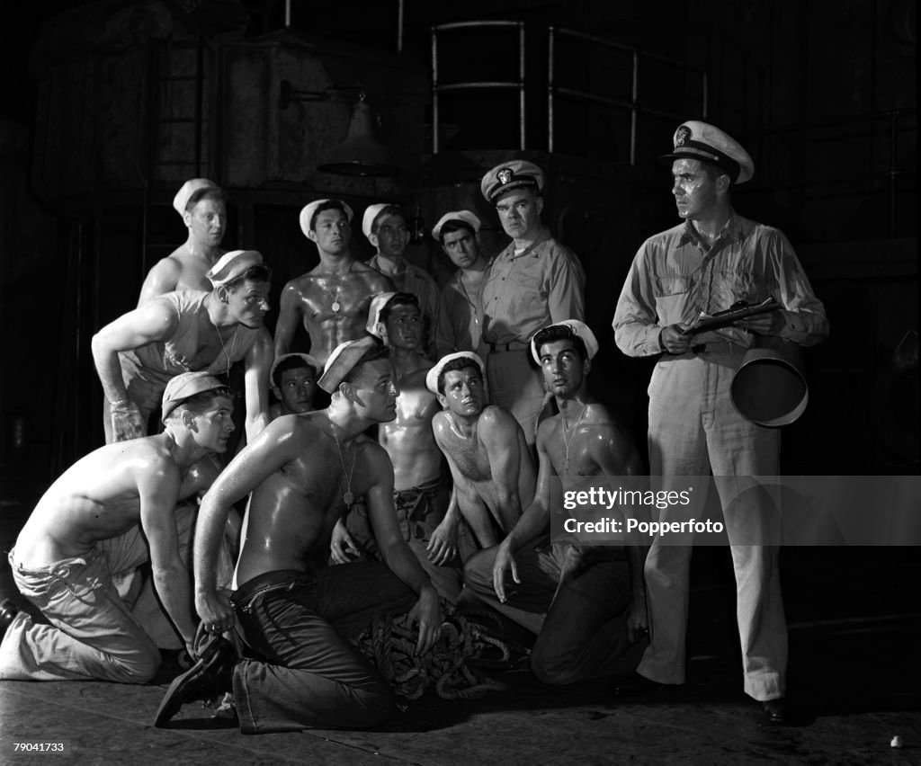 London, England. 1950. American actor Tyrone Power (right) is pictured in a scene from the play "Mister Roberts" at the Coliseum Theatre, as the rest of the cast look on.
