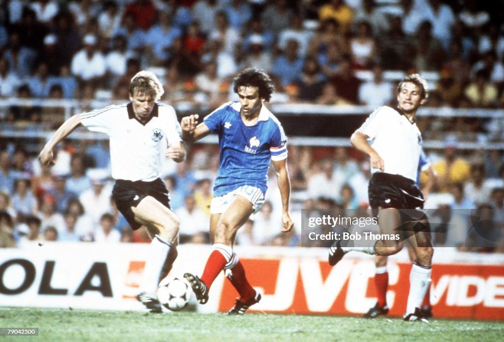 1982 World Cup Finals. Semi-Final. Seville, Spain. 8th July, 1982. West Germany 3 v France 3. (W. Germany win on penalties). West Germany's Bernd Foerster challenges France's Michel Platini.