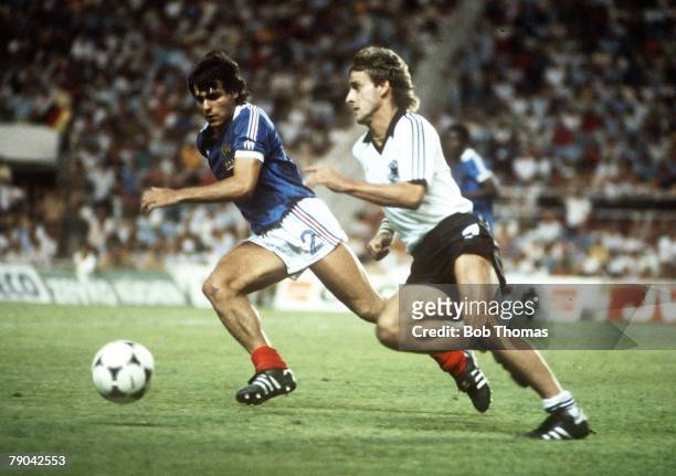 World Cup Finals, Semi-Final, Seville, Spain, 8th July West Germany 3 v France 3, , France's Manuel Amoros challenges West Germany's Pierre...