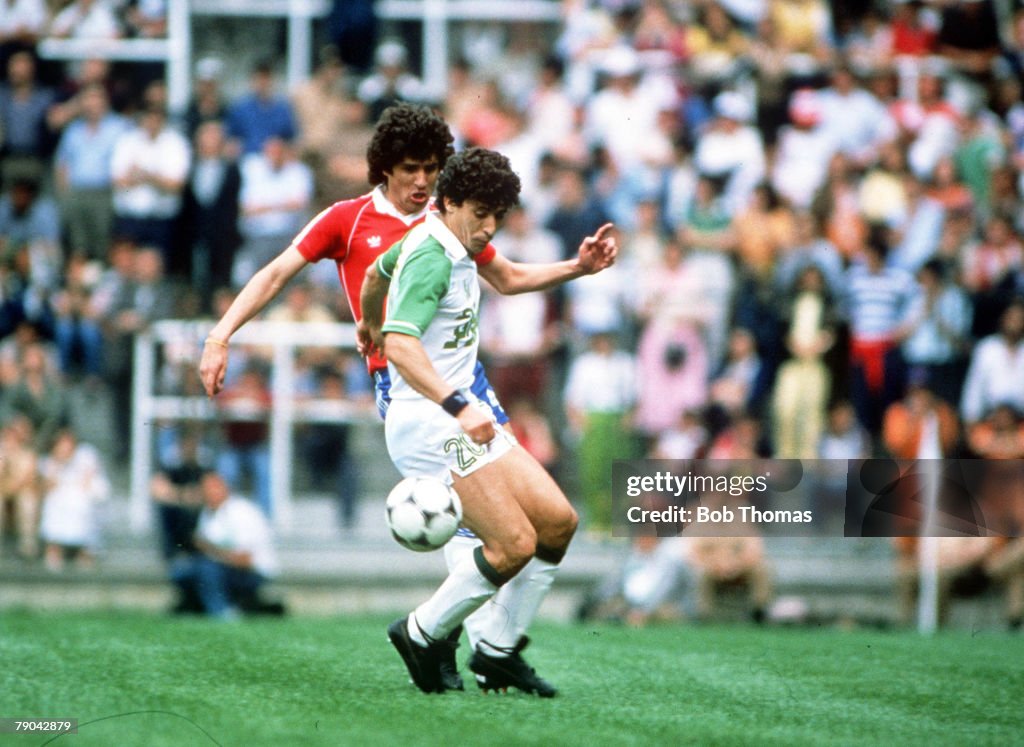 1982 World Cup Finals. Oviedo, Spain. 24th June, 1982. Algeria 3 v Chile 2. Algeria's Abdelmadjis Bourebbou is challenged by Chile's Vladimir Bigorra