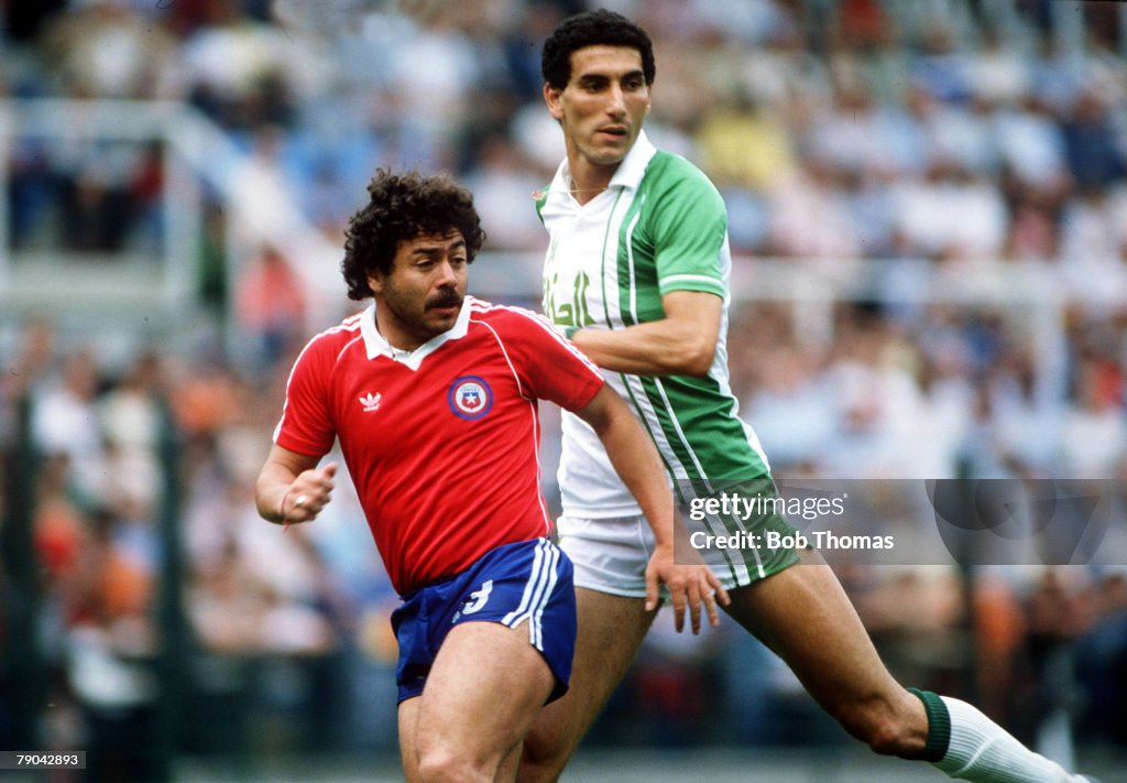 1982 World Cup Finals. Oviedo, Spain. 24th June, 1982. Algeria 3 v Chile 2. Algeria's Nourredine Kourichi battles for the ball with Chile's Carlos Caszely