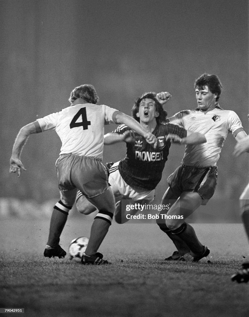 Football. English League Cup 5th Round. Ipswich, England. 18th January 1982. Ipswich Town 2 v Watford 1. Ipswich's Paul Mariner is fouled by Watford's Steve Terry (right) as Les Taylor looks on.