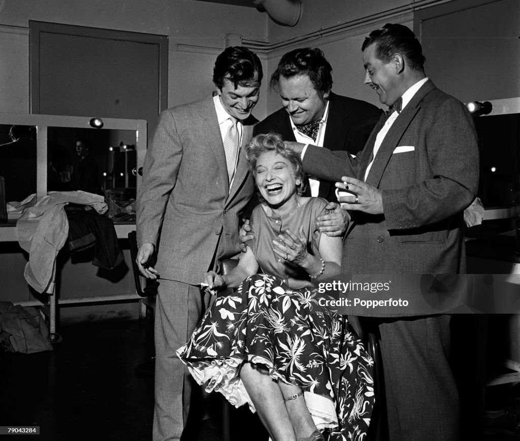London, England. 1955. L-R: singer Monty Norman, actress and entertainer Frances Day (seated), and comedian Harry Secombe are pictured with musician Eddie Calvert at the Lime Grove television studios.
