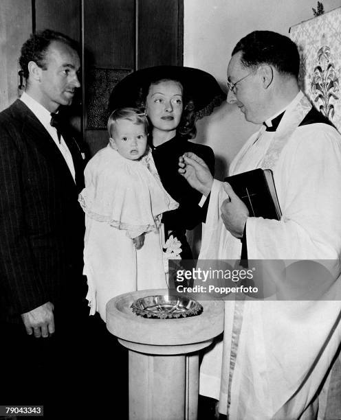 Cinema Personalities, pic: circa 1948, American film actress Bette Davis is pictured with her third husband William Grant Sherry at the Christening...