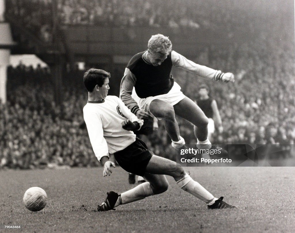 Sport. Football. 5th September 1966. League Division One. Upton Park, London, England. West Ham United v Liverpool. West Ham United's John Sissons leaps over a tackle from Liverpool's Chris Lawler.