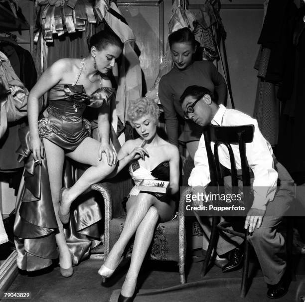 England British comedian and entertainer Peter Glaze is pictured in the dressing room at the Victoria Palace with three of the girls appearing in...