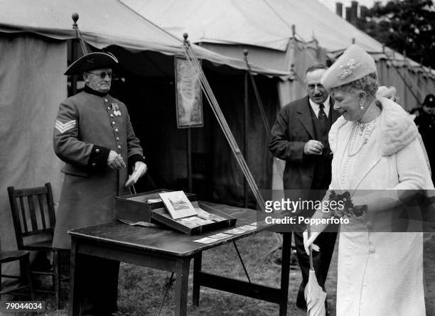 British Royalty, London, England, pic: 1939, H,M,Queen Mary, the wife of the late King George V, is pictured at the stall of a Chelsea pensioner...