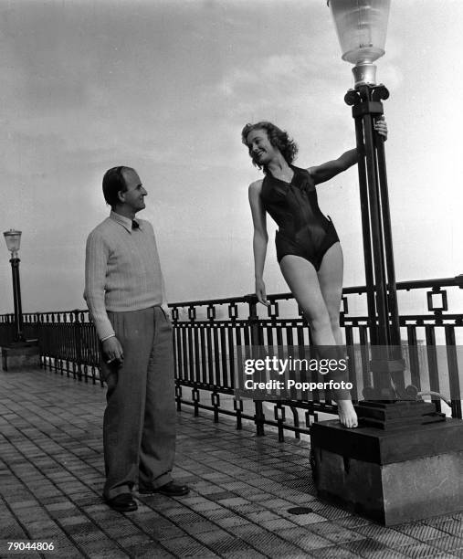 Folkestone, England Beauty Queen starlet and actress Pauline Stroud is pictured with Director Frank Launder on the set of the film "Lady Godiva Rides...