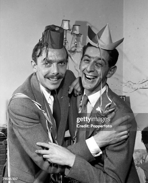 Picture of British comedians, writers and entertainers Frank Muir and Denis Norden at a Christmas party