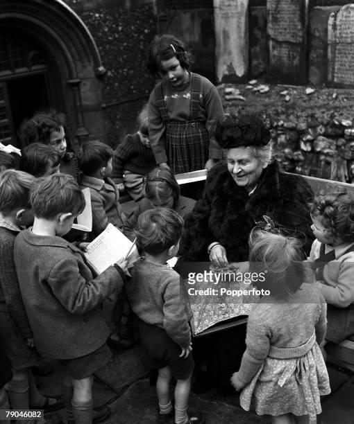 London, England Italian educational reformer Maria Montessori, who evolved the Montessori method of teaching children, is pictured during a visit to...