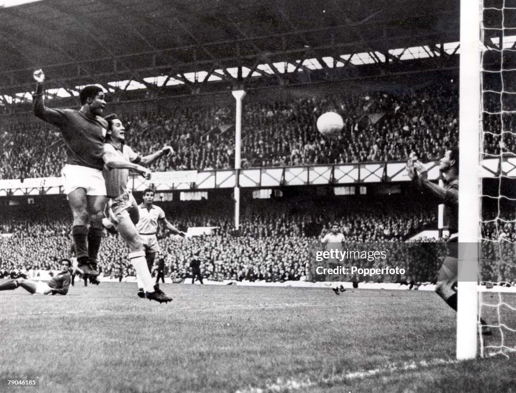 World Cup Finals, 1966. Liverpool, England. 19th July, 1966. Portugal 3 v Brazil 1. Eusebio of Portugal (L) beats Brazil's Orlando to the ball to head home his side's second goal past Brazilian goalkeeper Manga during their Group Three match