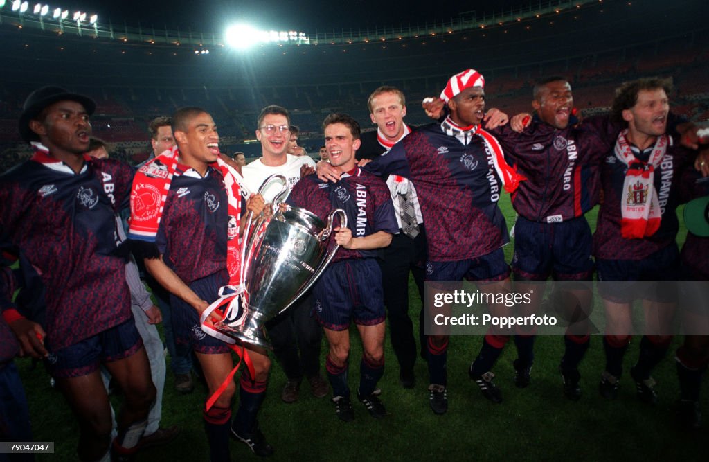 Football. UEFA Champions League Final. Vienna, Austria. 24th May 1995. Ajax 1 v AC Milan 0. Members of the Ajax team celebrate with the trophy. Players in Ajax shirts L-R: Finidi George, Michael Reiziger, Marc Overmars, Nwankwo Kanu, Winston Bogarde and c