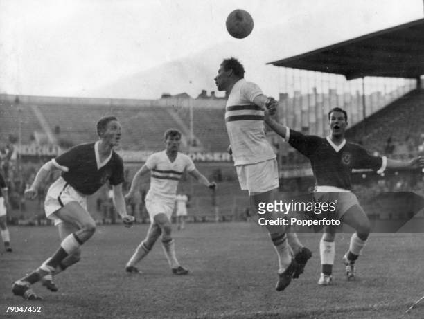 World Cup Finals, Stockholm, Sweden, 17th June Hungary 1 v Wales 2, Hungarian centre Budai jumps for the ball watched by teammate Tichy as Wales'...
