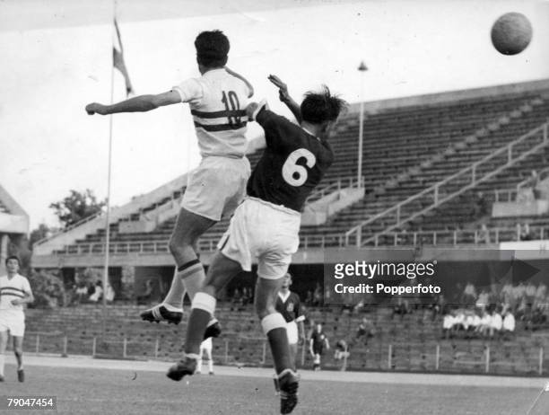 World Cup Finals, Stockholm, Sweden, 17th June Hungary 1 v Wales 2, Hungarian inside right Bundszak jumps for the ball with a Welsh defender during...