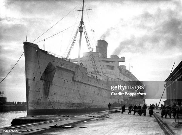 Shipping, World War II, pic: circa 1943, The Cunard liner "Queen Mary" in it's drab wartime colours arrives in port, The ship was commissioned as a...