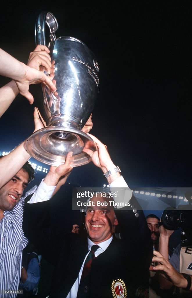 Football. European Cup Final. Vienna, Austria. 23rd May 1990. AC Milan 1 v Benfica 0. AC Milan coach Arrigo Sacchi holds the trophy aloft.