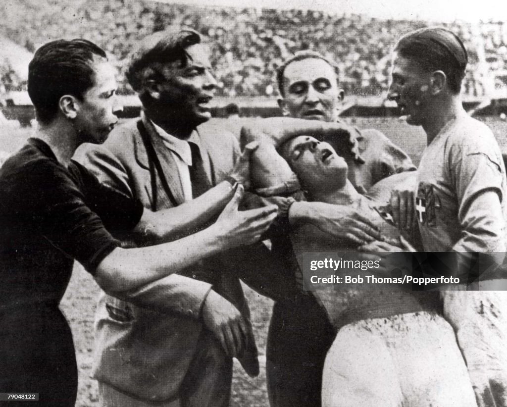 1934 World Cup Quarter-Final, Florence, Italy. 31st May, 1934. Italy 1 v Spain 1. Italy's Giuseppe Meazza is helped from the field by teammates after being injured.