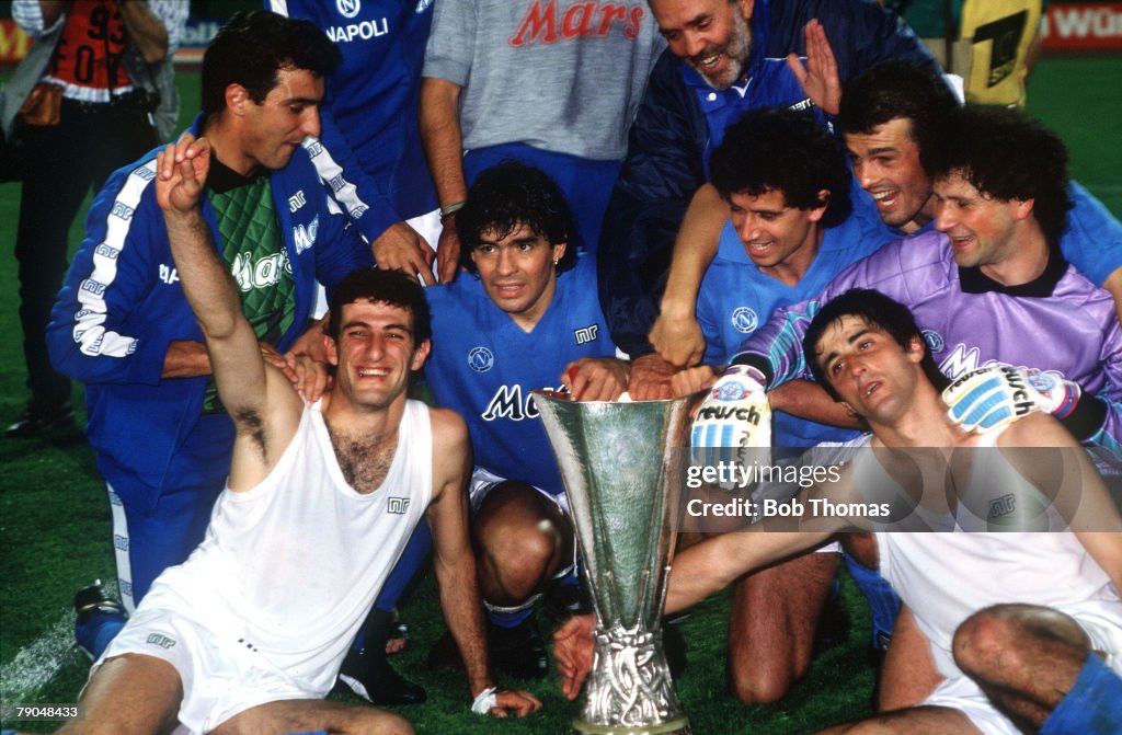 Football. UEFA Cup Final, Second Leg. Naples, Italy. 17th May 1989. Napoli 2 v VfB Stuttgart 1 (Napoli win 5-4 on aggregate). Napoli captain Diego Maradona (centre) holds the trophy as he celebrates with his team-mates.