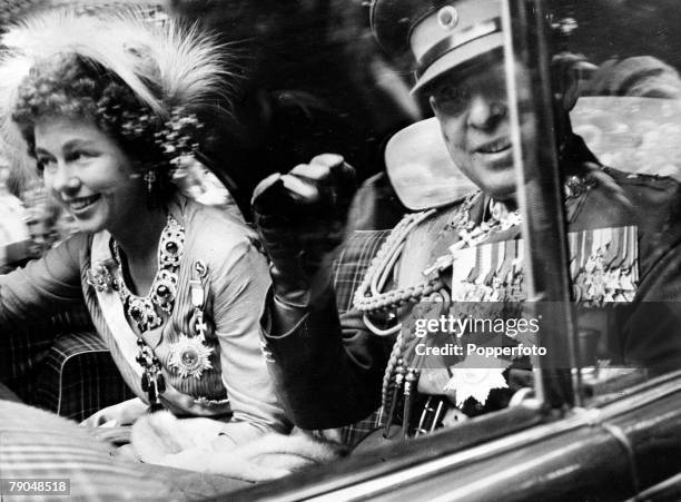 Circa 1940's, Queen Friederika, born 1917, waving to the crowd alongside her husband King Paul, , The couple married in 1938