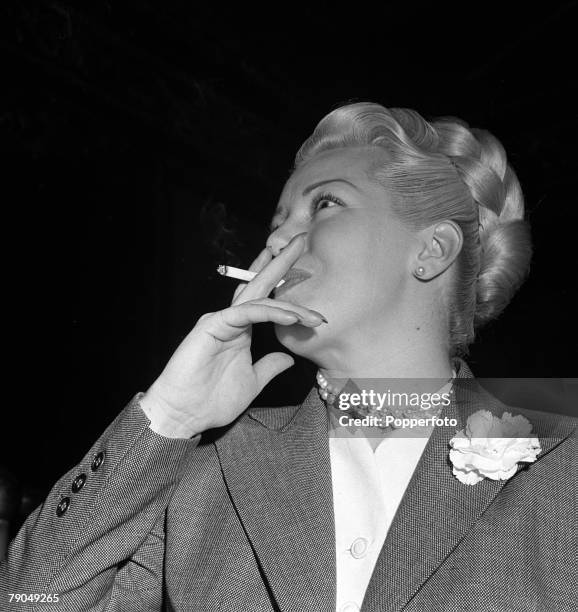 London, England, A picture of American actress Lana Turner smoking a cigarette