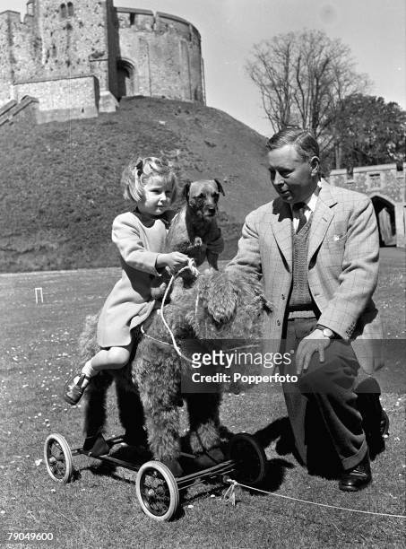 Arundel Castle, Sussex, England, A picture of the Duke of Norfolk, watching his daughter Lady Jane Howard play on a rocking horse with her pet...