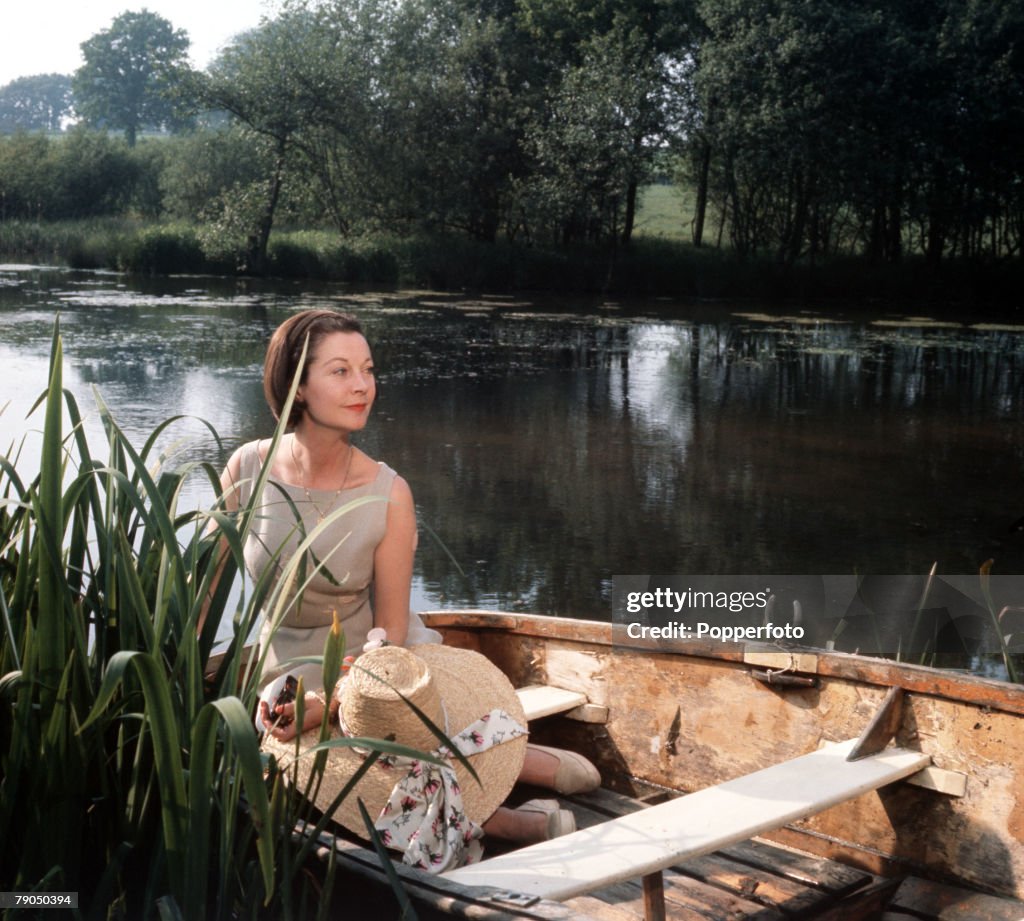 England. Circa 1960's. British actress Vivien Leigh is pictured on the lake at Tickerage Mill.