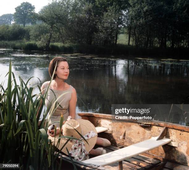 England, Circa 1960's, British actress Vivien Leigh is pictured on the lake at Tickerage Mill