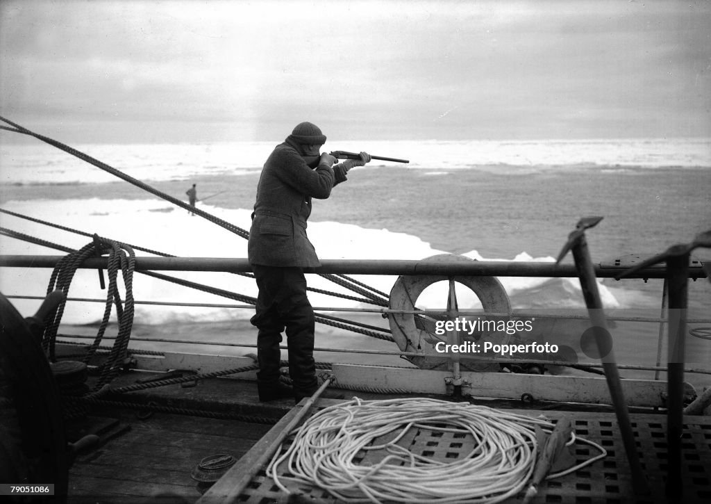 H.G Ponting. Captain Scott+s Antarctic Expedition 1910 - 1912. 17th December, 1910. Dr. Wilson aims his rifle while practicing shooting on the deck of the "Terra Nova" ship.