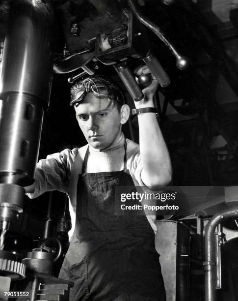 Classic Collection, Page 46 Young man wearing apron and goggles using large mechanical drill, Brooklyn Technical High School, Brooklyn, New York,...