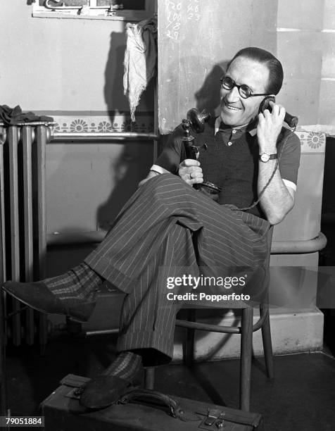 London, England, 8 November 1940, Arthur Askey makes a telephone call from his dressing room at the Gaumont Studios, Shepherds Bush during a break...