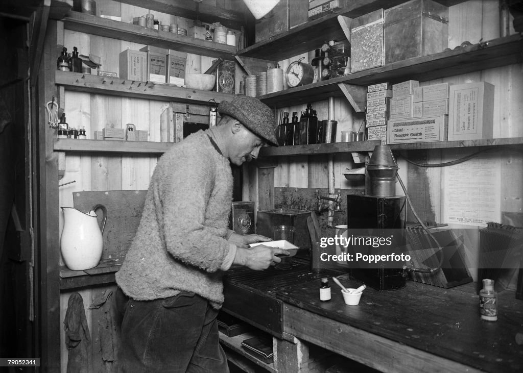 H.G Ponting. Captain Scott+s Antarctic Expedition 1910 - 1912. 24th March, 1911. An interior view showing photographer Herbert Ponting at work in his darkroom.