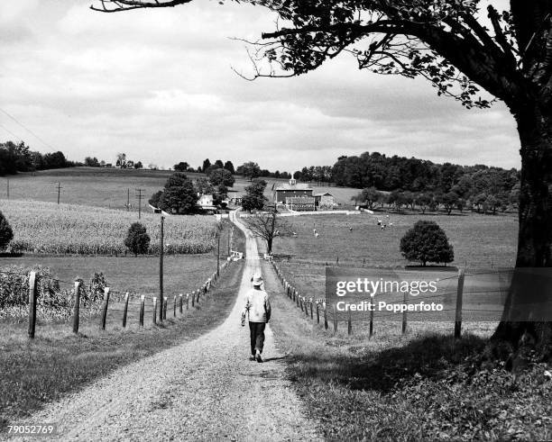 Classic Collection, Page 138 New Jersey, USA, A man in the centre of the picture walks down a long lane towards a farmhouse, with fields on either...