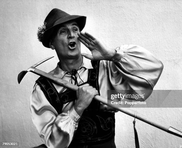 Classic Collection, Page 132 Man in Austrian traditional dress, seen yodelling, holding an ice- pick