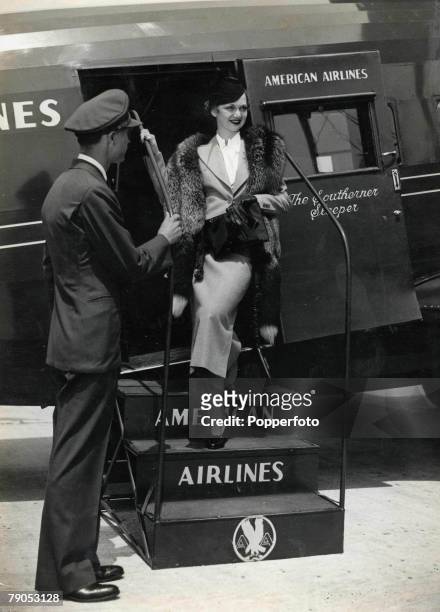 Classic Collection, Page 110 New York, USA, A smiling female passenger disembarks from an American airlines aeroplane, after a coast to coast trip...