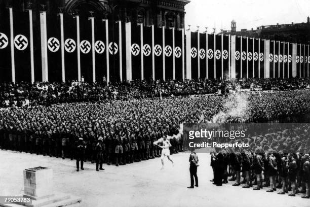Volume 2, Page 23, Picture 3, 1936 Olympic Games, Berlin, Germany, The Olympic flame arrives at the Opening Ceremony to a packed stadium covered with...