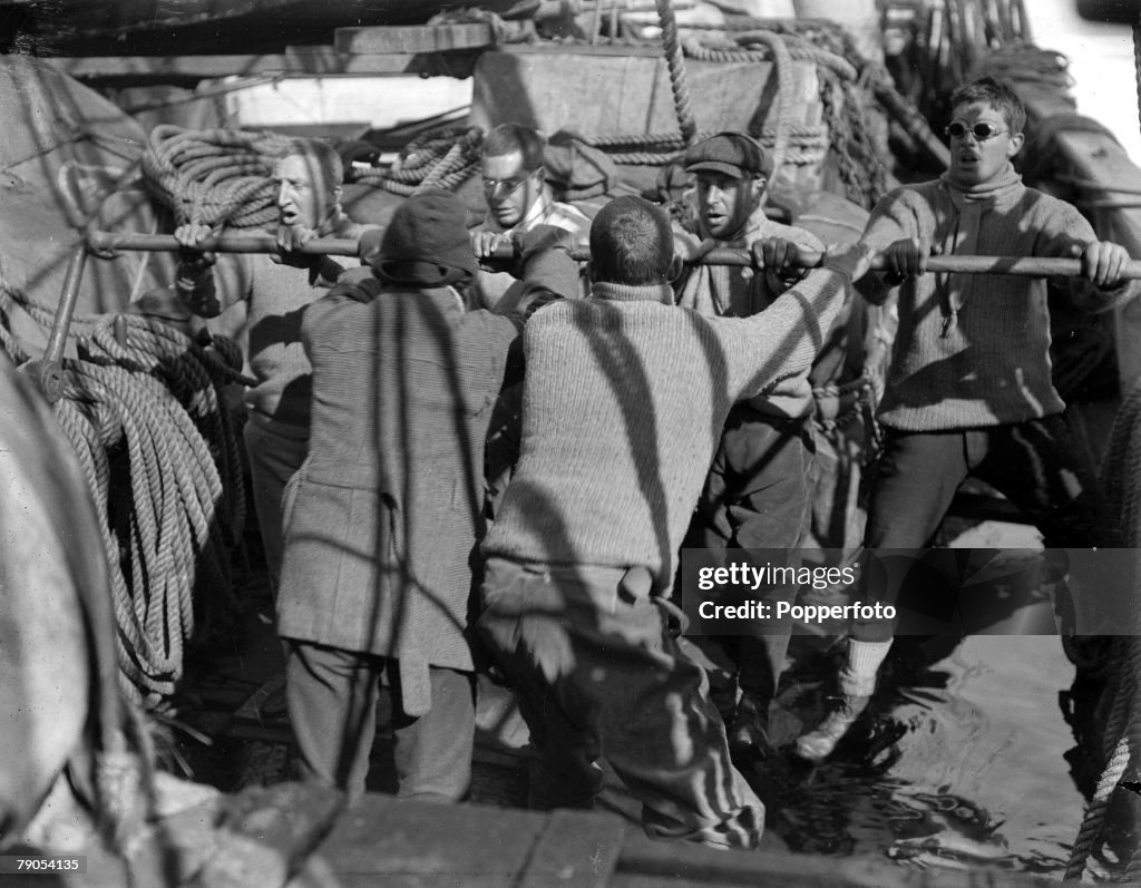 H.G Ponting. Captain Scott+s Antarctic Expedition 1910 - 1912. December, 1910. Expedition team members working the pumps on board the Terra Nova ship.