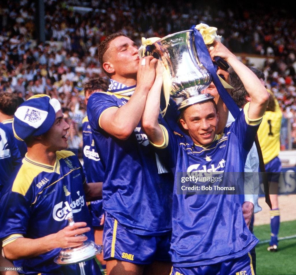 F.A.Cup Final. Wembley. 14th May 1988. Liverpool 0 v Wimbledon 1. Wimbledon's Vinnie Jones kisses the cup which is held by Terry Phelan, as Dennis Wise looks on.