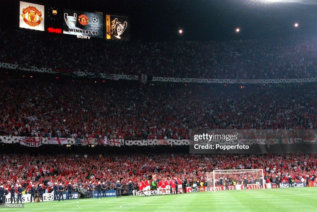 26th MAY 1999. UEFA Champions League Final. Barcelona, Spain. Manchester United 2 v Bayern Munich 1. The Nou Camp scoreboard shows Manchester United as European Champions as they parade the trophy to their fans after the match.