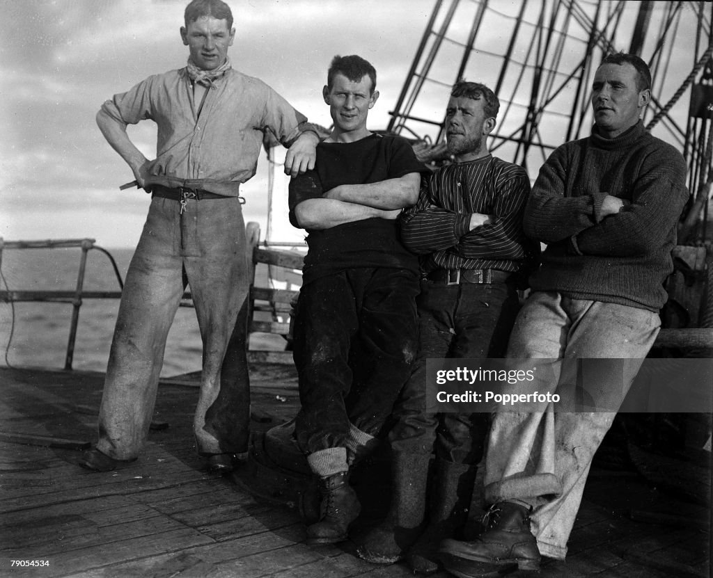 H.G Ponting. Captain Scott+s Antarctic Expedition 1910 - 1912. Full length portrait of crew members looking relaxed on the fo'castle on board the Terra Nova off the coast of New Zealand.