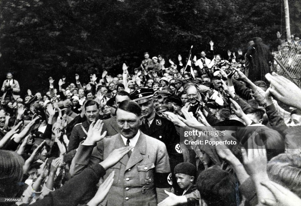 Volume 2. Page 40. Picture 1. Nazi leader Adolf Hitler waves to the crowd as he is given the Nazi salute by thousands of supporters.