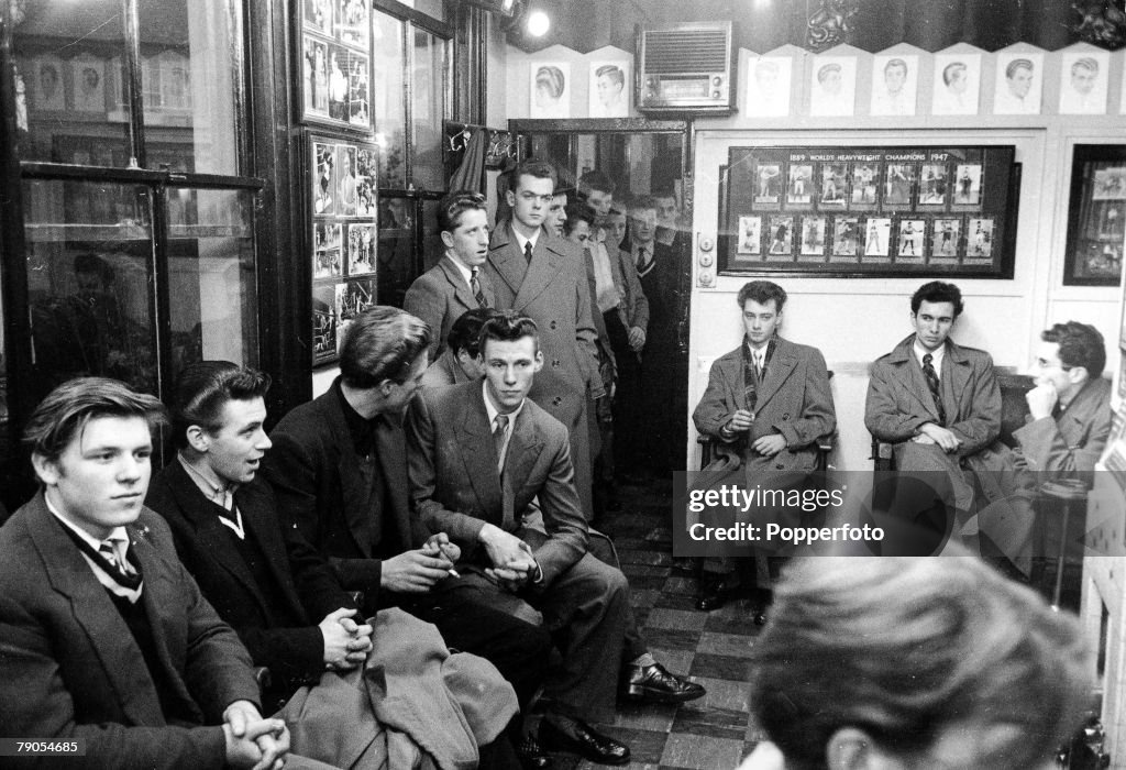 Volume 2. Page: 47. Picture 9. Hounslow, England. 1953. A group of teenage boys queuing up to have their hair styled in a hairdressers.