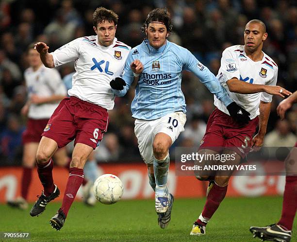 Roland Bianchi of Manchester City vies with Matthew Upson and Anton Ferdinand of West Ham United during the Fa cup third round replay football match...