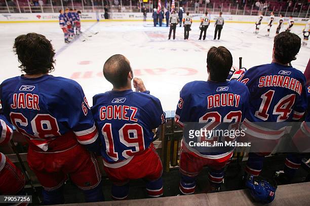 Jaromir Jagr, Scott Gomez, Chris Drury, and Brendan Shanahan of the New York Rangers stand on the bench during the national anthem before playing the...