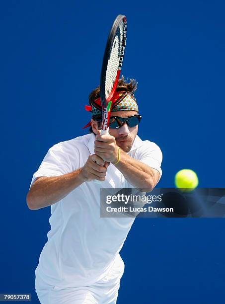 Arnaud Clement of France plays a backhand during his doubles match with Michael Llodra of France against Sanchai Ratiwatana and Sonchat Ratiwatana of...