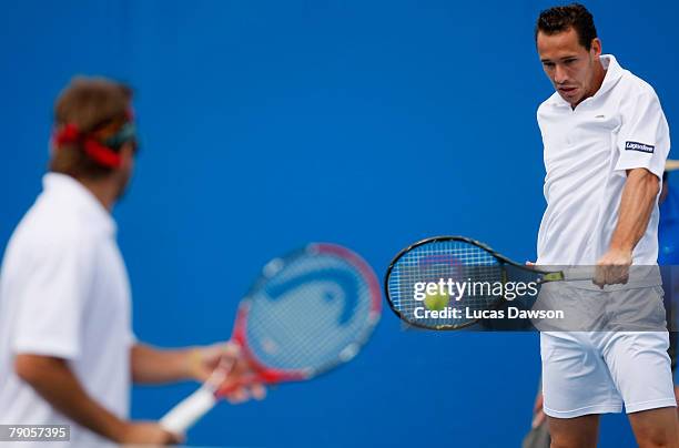 Michael Llodra of France plays a backhand during his doubles match with Arnaud Clement of France against Sanchai Ratiwatana and Sonchat Ratiwatana of...