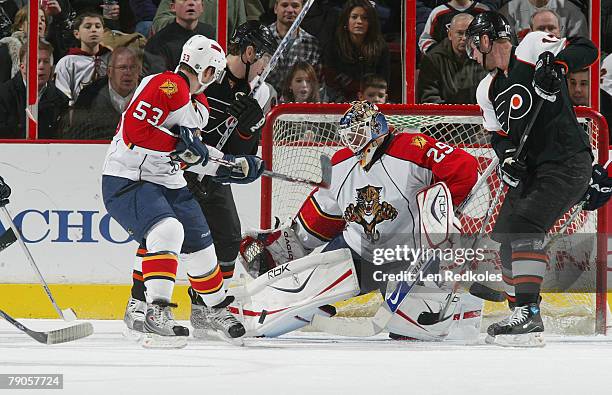 Scottie Upshall and Jeff Carter of the Philadelphia Flyers take a shot on goal against Brett McLean and Tomas Vokoun of the Florida Panthers on...